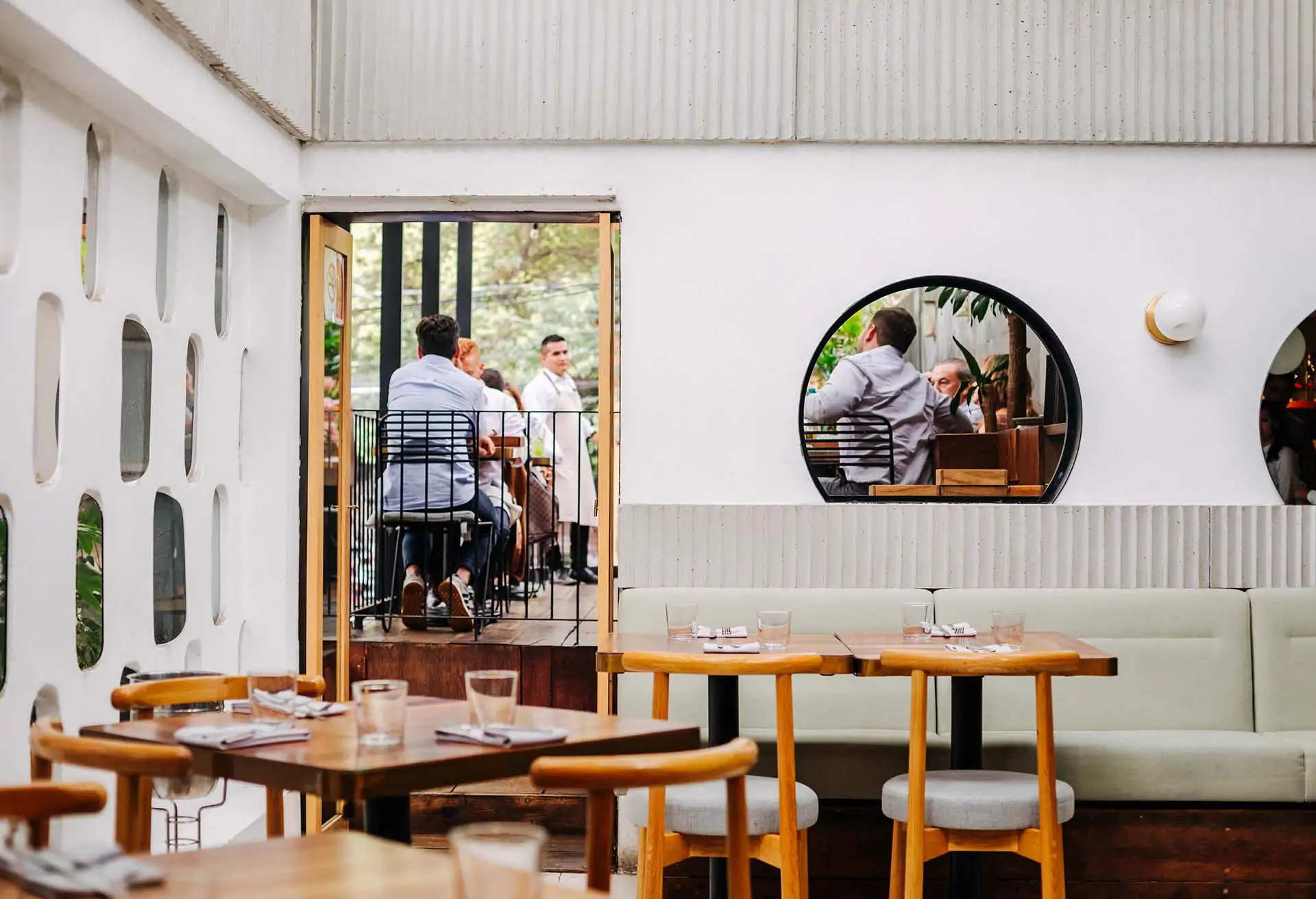 Image depicts a restaurant setting with lots of empty tables