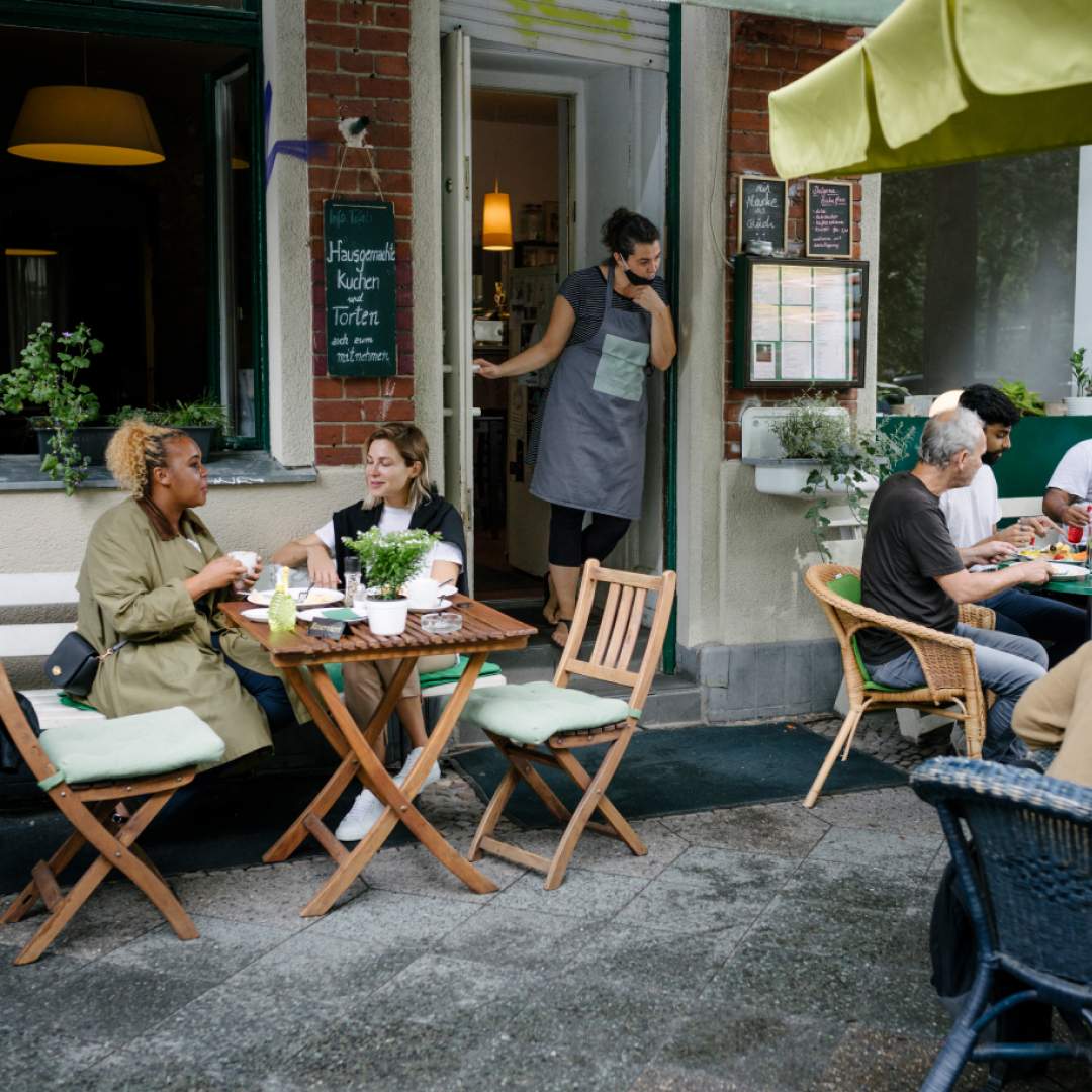 Terrace of a restaurant with guests and a waiter