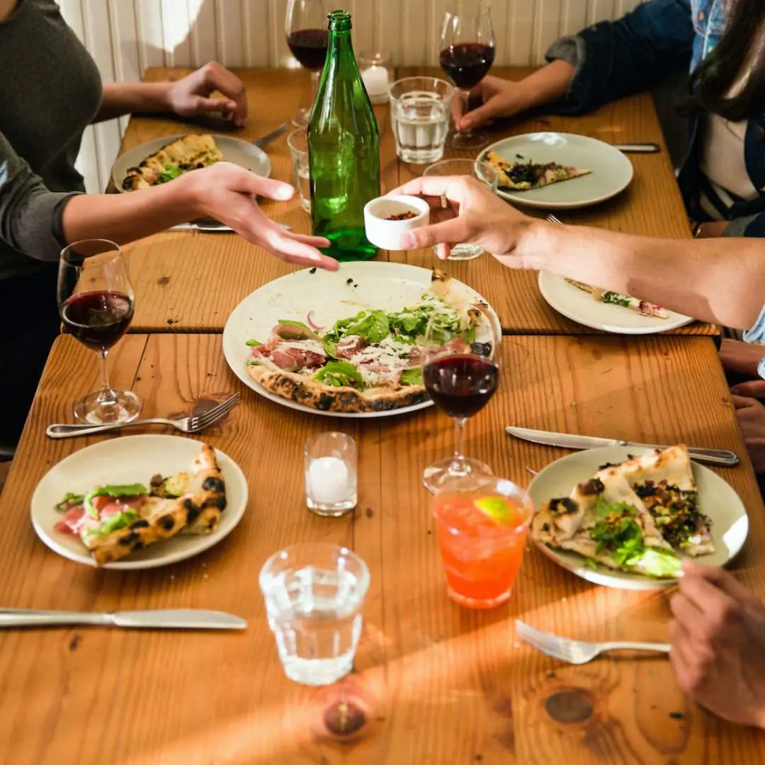 A photo of a restaurant table with plates and glasses for promoting a restaurant on social media.